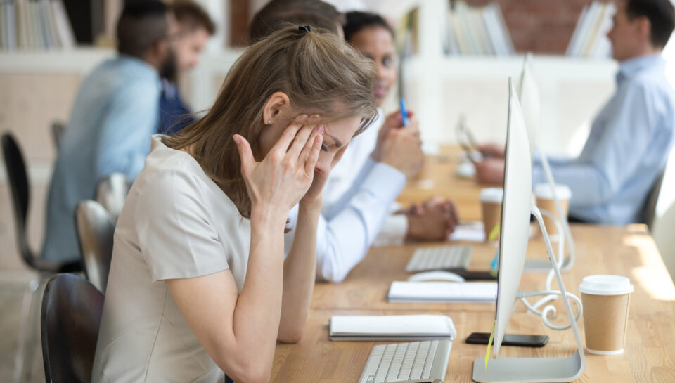 Sick woman distracted from work feeling unwell sitting in front of computer, stressed female employee have anxiety attack at workplace, upset woman suffer from headache or dizziness in office